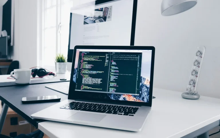 Laptop displaying code on a desk